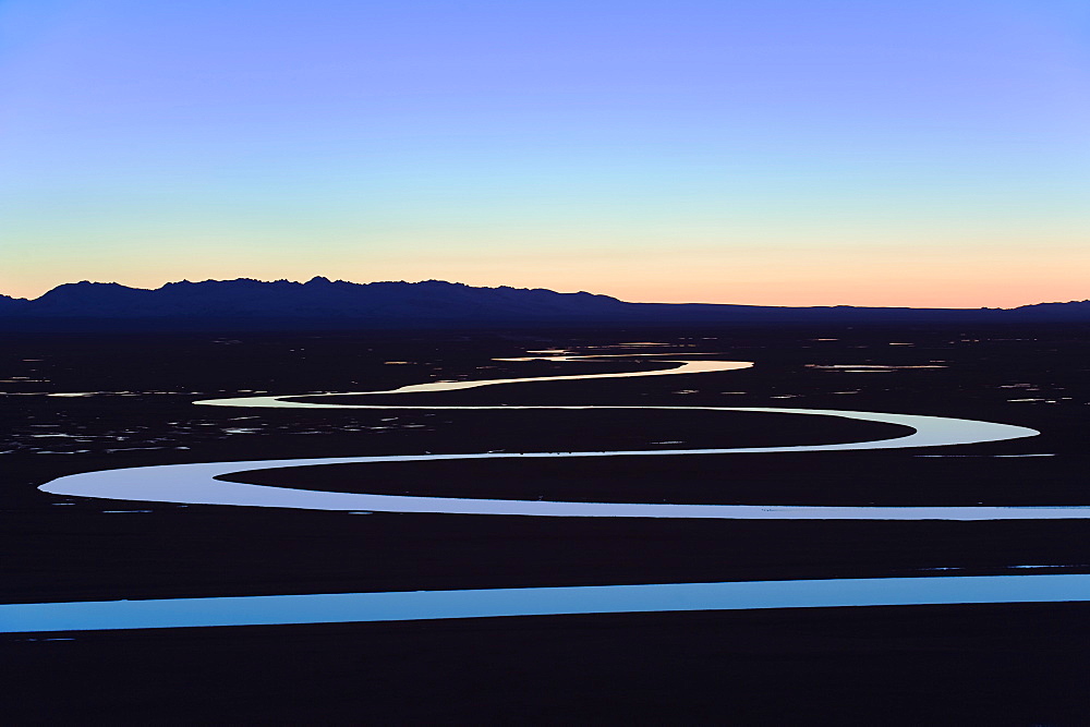 The night sky reflecting in a winding river, Bayanbulak, Xinjiang Province, China, Asia