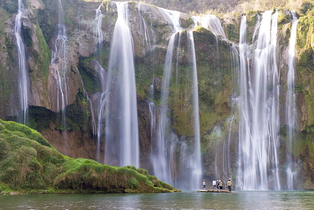 Tourists on a bamboo raft under Jiulong Falls (Nine Dragon waterfall), Luoping, Yunnan Province, China, Asia