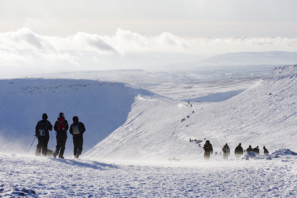 Hikers on snow covered Pen y Fan mountain, Brecon Beacons National Park, Powys, Wales, United Kingdom, Europe