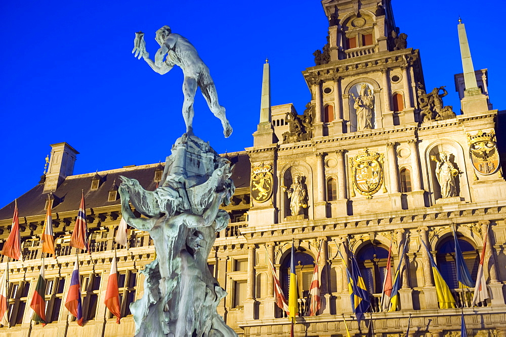 Baroque Brabo fountain dating from 1887 by Jef Lambeaux, and Stadhuis (City Hall) illuminated at night, Antwerp, Flanders, Belgium, Europe