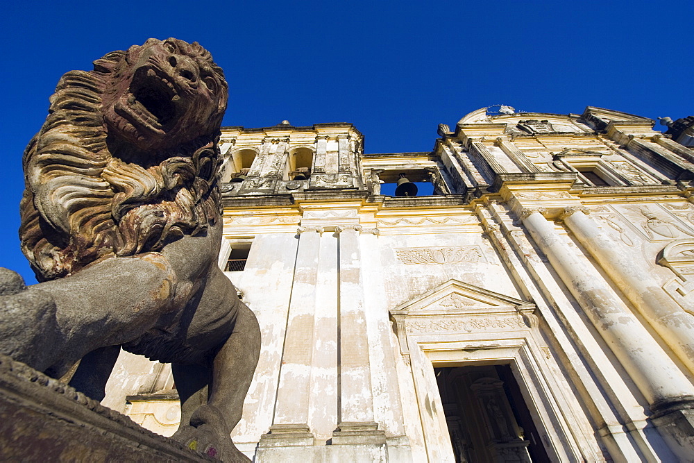 Stone statue of a lion outside Leon Cathedral, Basilica de la Asuncion, Leon, Nicaragua, Central America