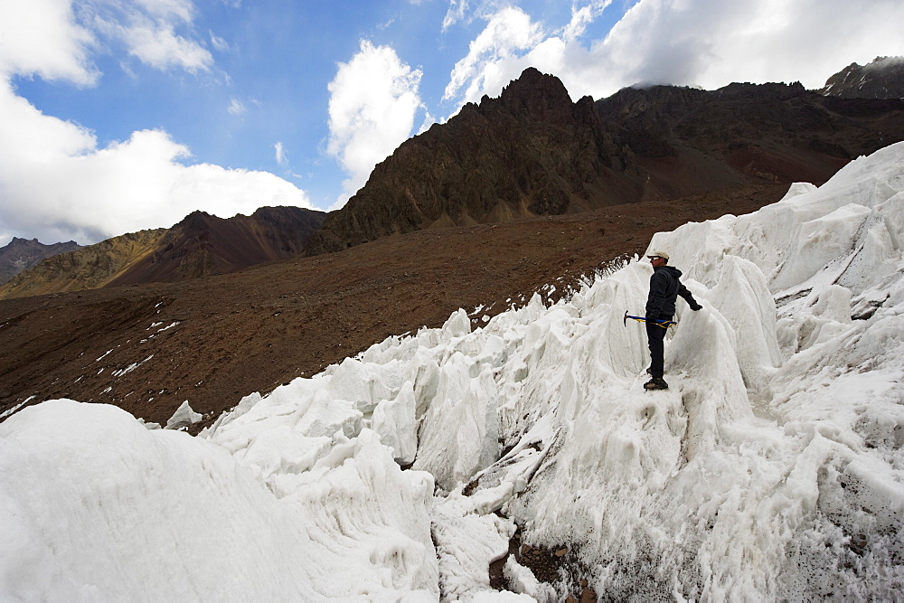 Climber ice climbing on glacier near Plaza de Mulas basecamp, Aconcagua Provincial Park, Andes mountains, Argentina, South America