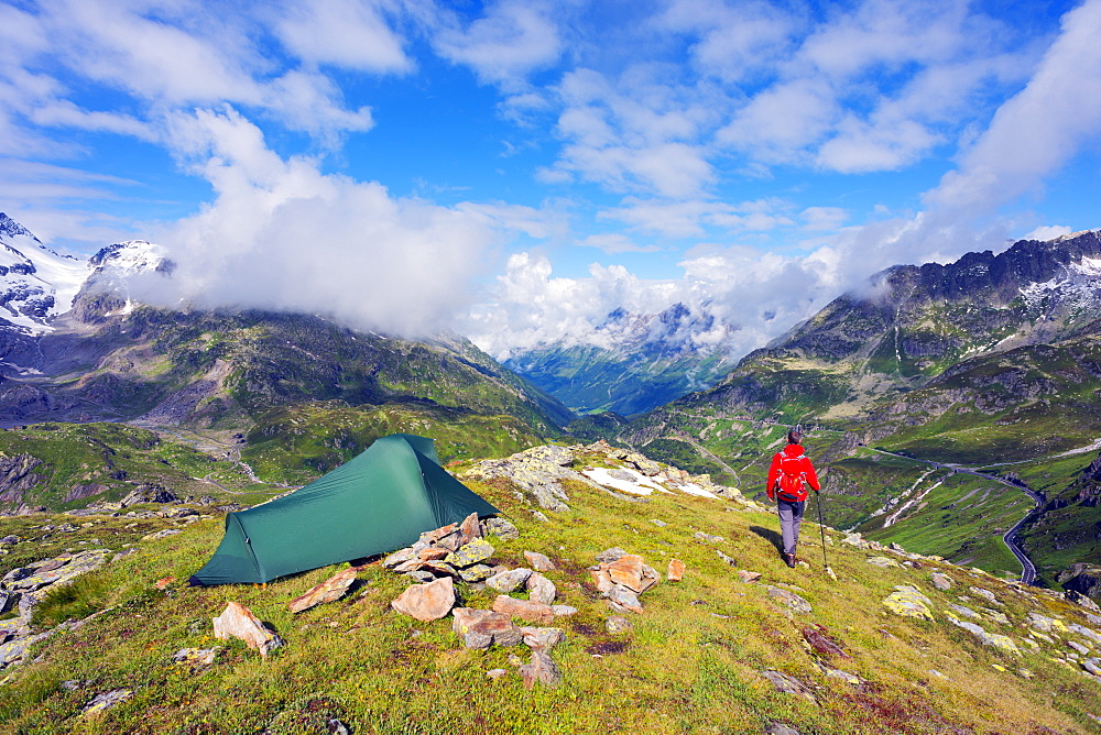 Hiker and camp site, Sustenpass (Susten Pass), Swiss Alps, Switzerland, Europe