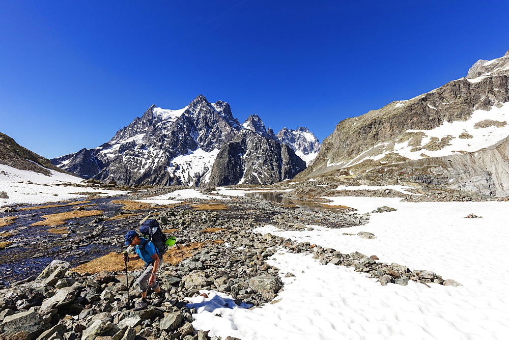 Hiker on a mountain trail, Barre des Ecrins, Ecrins National Park, French Dauphine Alps, Haute Alpes, France, Europe