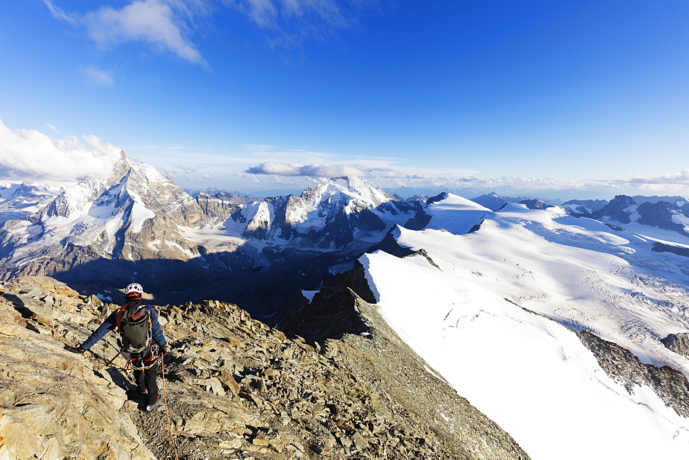 Climber on south ridge of Dent Blanche, 4357m, with view to the Matterhorn, Valais, Swiss Alps, Switzerland, Europe