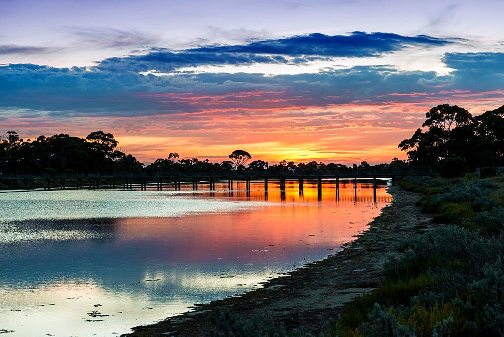 Sunset colours over Laverton Creek and bridge, Altona, Victoria, Australia