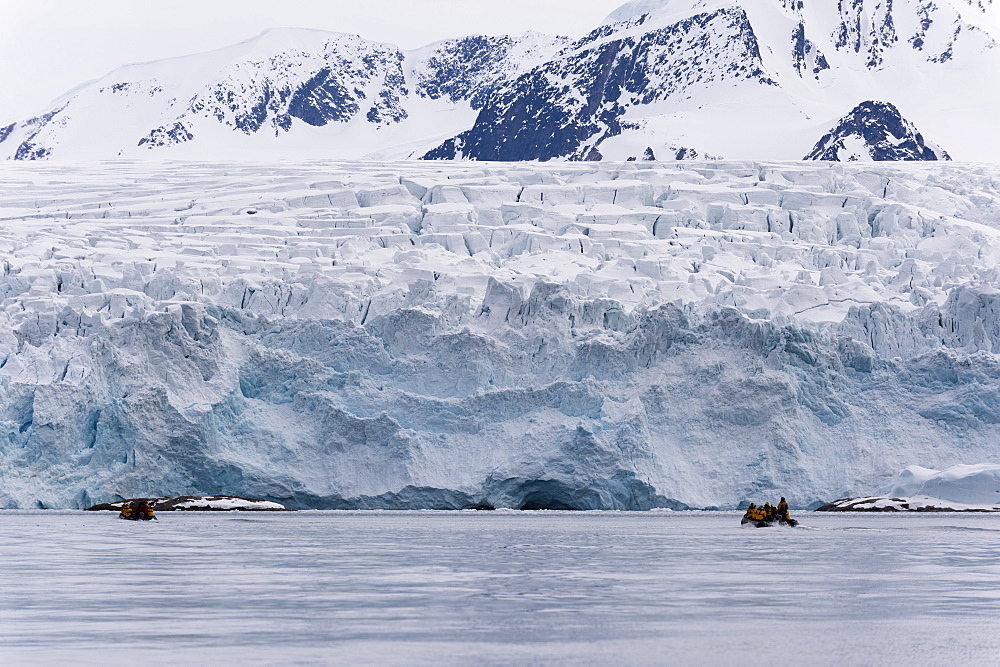 Tourist on inflatable boat exploring Fuglefjorden, Spitsbergen, Svalbard, Arctic, Norway, Europe, Norway.