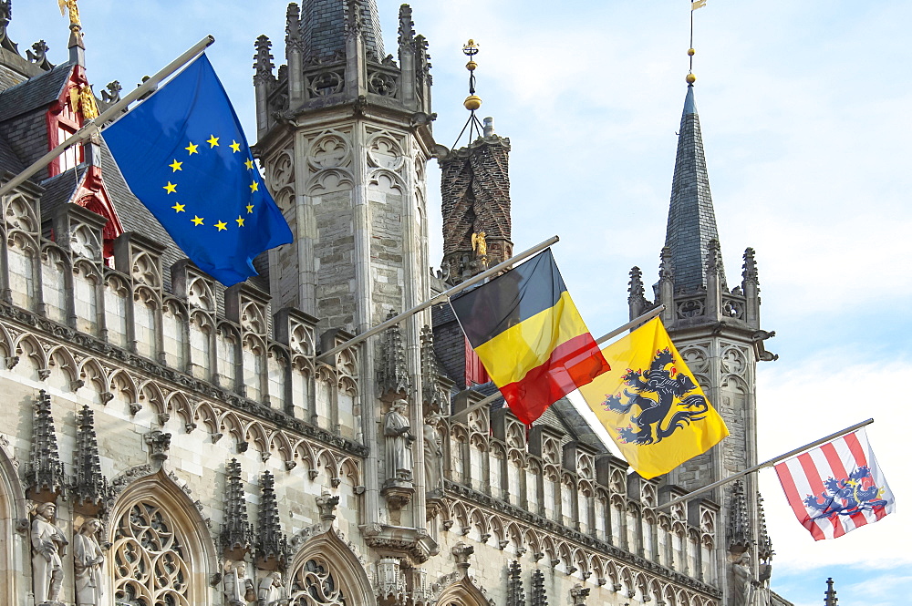 The 14th cenury Stadhuis (City Hall) with National and Regional Flags, Burg Square, Brugge (Bruges), UNESCO World Heritage Site, West Flanders, Belgium, Europe