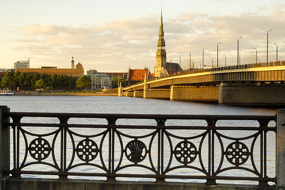 Church of St. Peter and the Old Town at dusk from across the river Daugava, Riga, Latvia, Baltic States, Europe