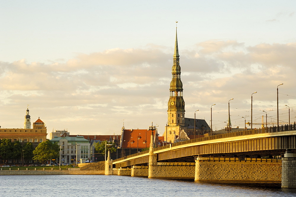 Church of St. Peter and the Old Town at dusk from across the river Daugava, Riga, Latvia, Baltic States, Europe