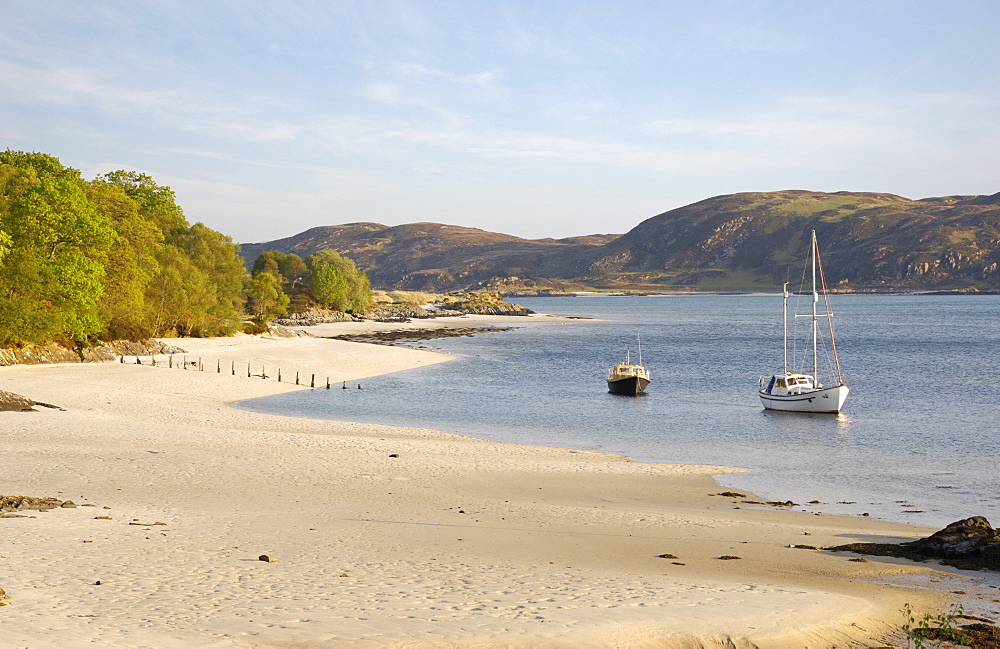 Yacht at anchor off a sandy beach at Morar, Highlands, Scotland, United Kingdom, Europe