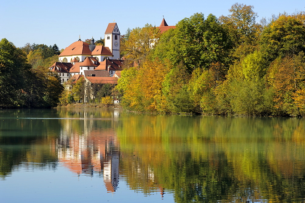 St. Mang Monastery and Basilica reflected in the river Lech, Fussen, Bavaria (Bayern), Germany, Europe