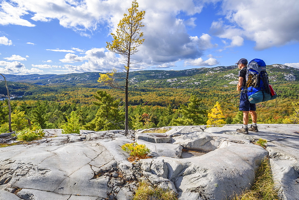 Hiker on La Cloche Silhouette Trail in Killarney Provincial Park, Ontario, Canada, North America