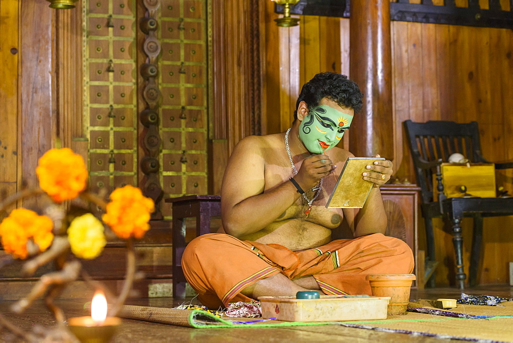 Man applying makeup for Kerala Kathakali performance in Kochi, Kerala, India, Asia