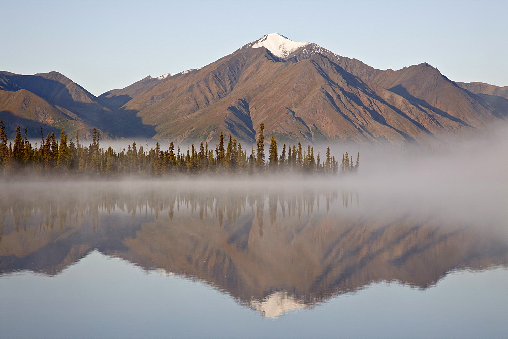 Mountain reflected in a lake with fog, Denali Highway, Alaska, United States of America, North America