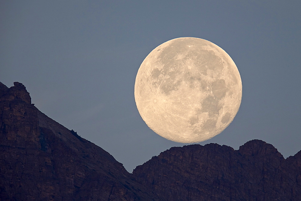 Full moon setting above a ridge, Glacier National Park, Montana, United States of America, North America