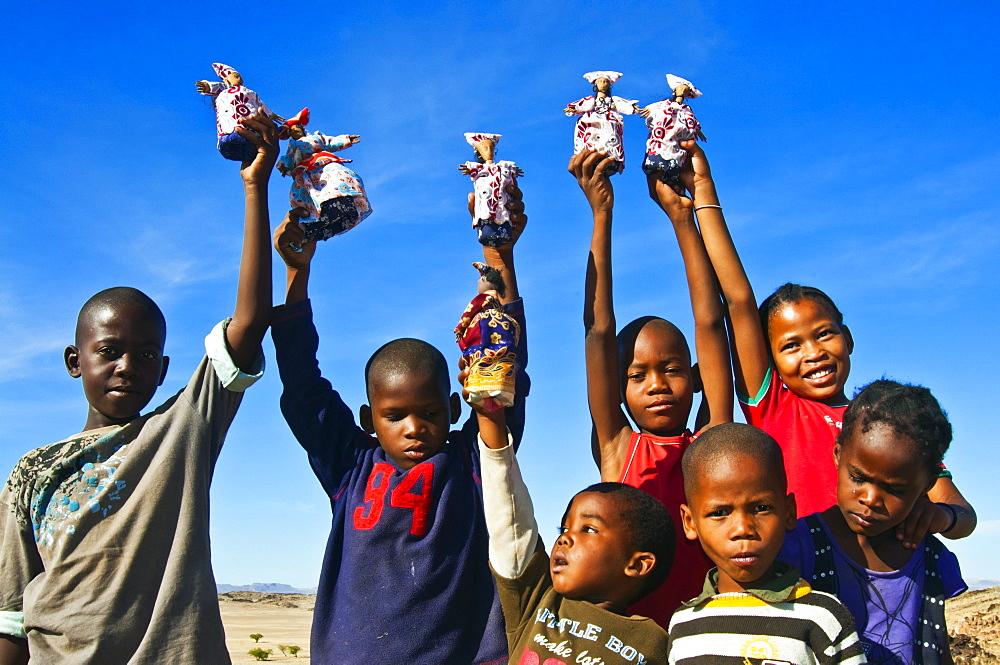 Herero children selling Herero dolls, Damaraland, Kunene Region, Namibia, Africa