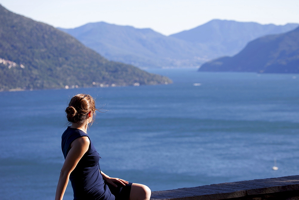 Woman looking across Lake Maggiore, Canton Tessin, Switzerland, Europe