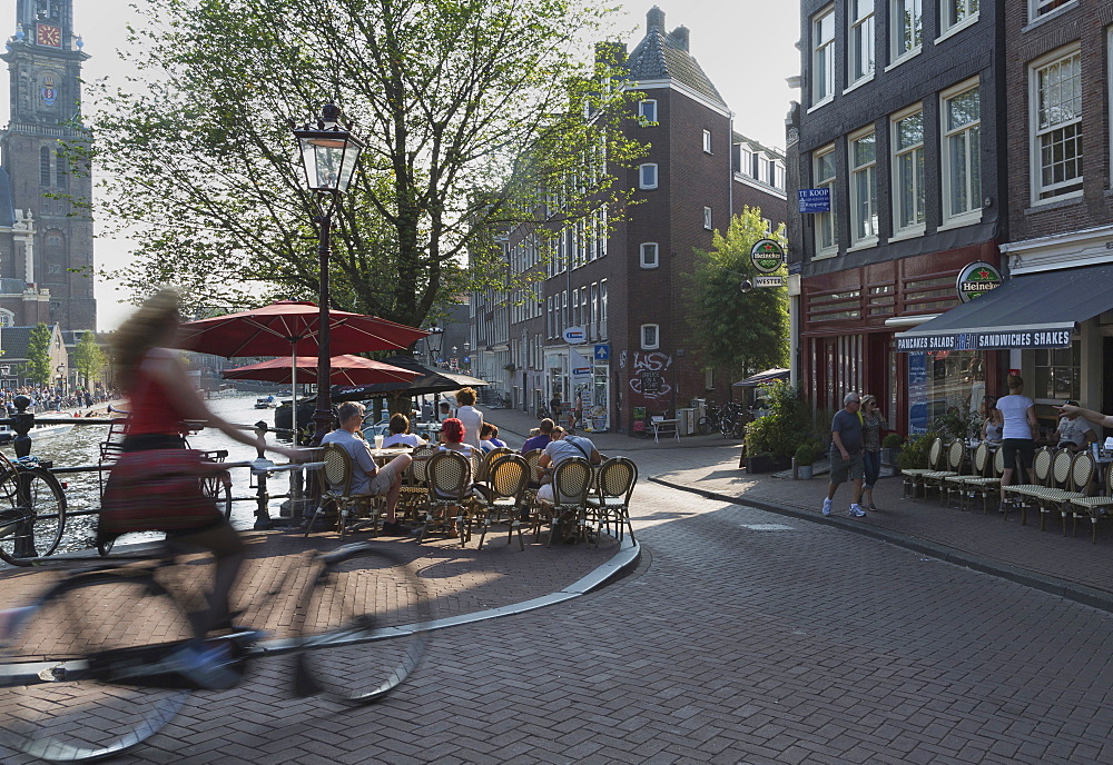 Cyclist and pavement cafe, Amsterdam, The Netherlands, Europe