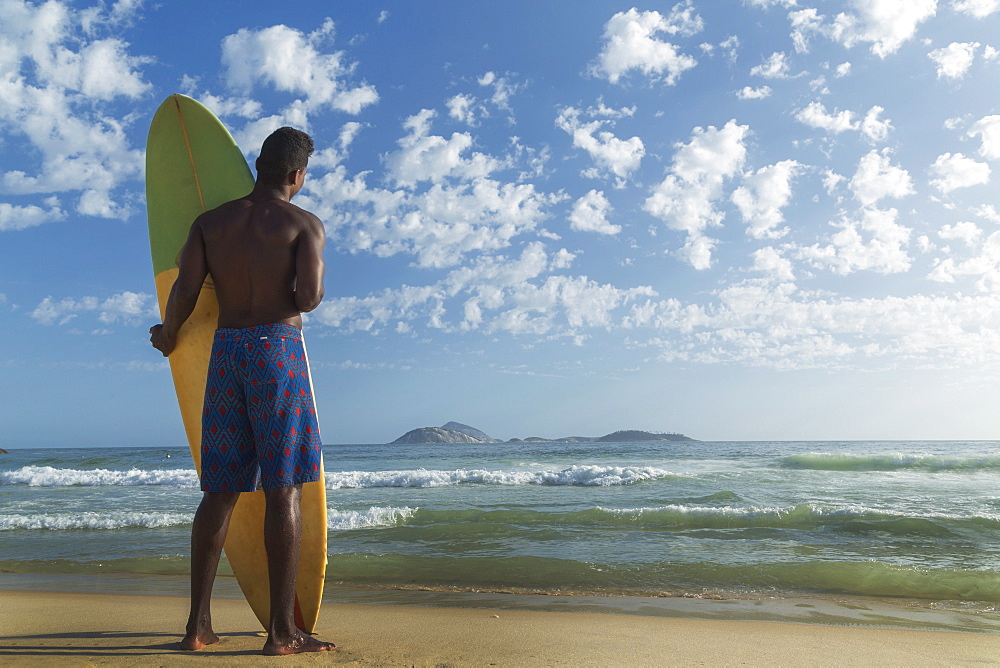 Young man with surfboard, Rio de Janeiro, Brazil, South America