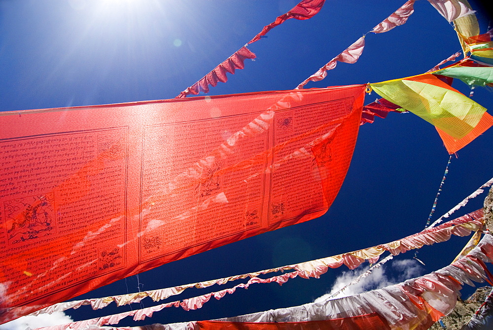 Red prayer flags against blue sky, Yushu, Qinghai, China, Asia