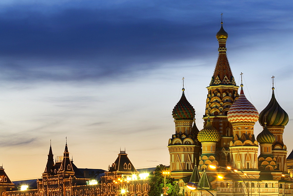 The onion domes of St. Basil's Cathedral and Gum department store in Red Square illuminated at night, UNESCO World Heritage Site, Moscow, Russia, Europe