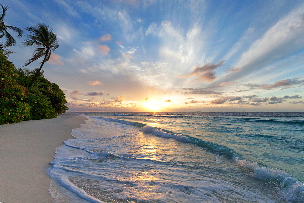 Sunrise over the Indian Ocean from a deserted beach in the Northern Huvadhu Atoll, Maldives, Indian Ocean, Asia