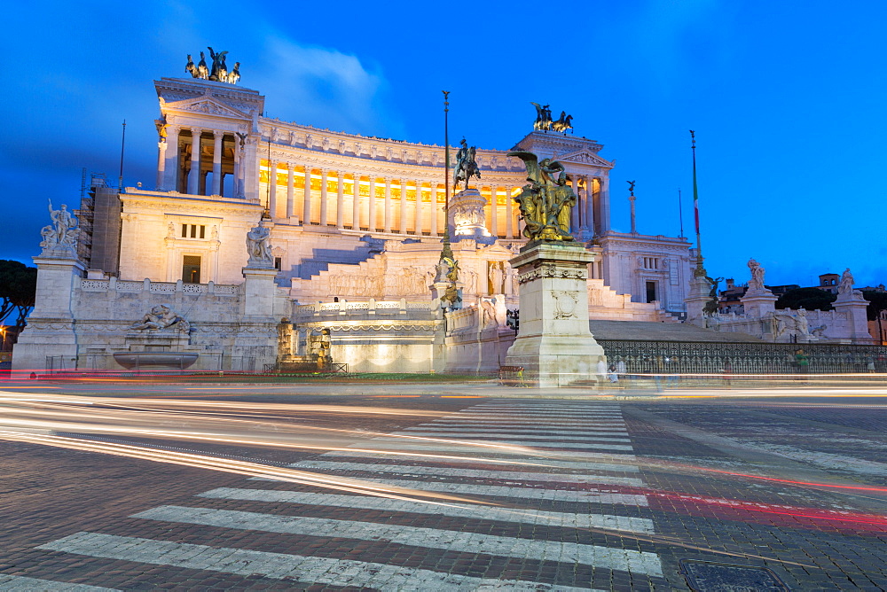 Moving traffic around Piazza Venezia with the Victor Emmanuel Monument at night, Rome, Lazio, Italy, Europe