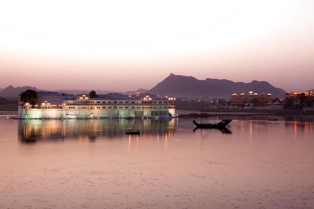 Perfect reflection of Lake Palace Hotel at dusk, situated in the middle of Lake Pichola, in Udaipur, Rajasthan, India, Asia