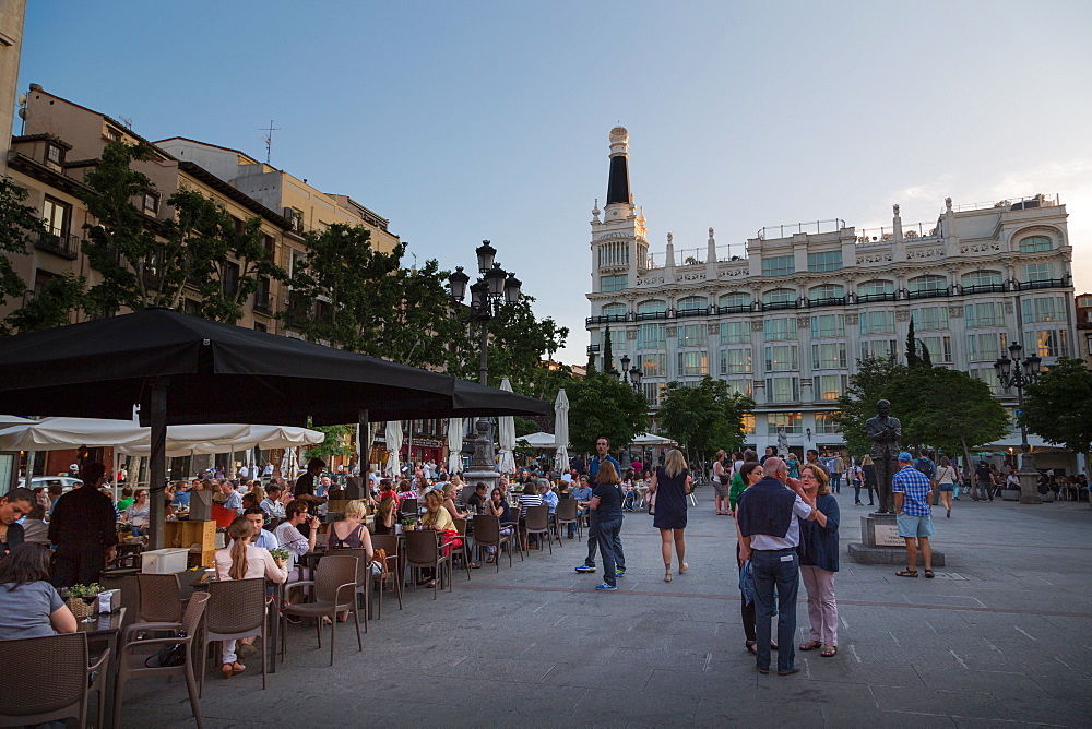 People relaxing in in the evening in Plaza de Santa Ana in Madrid, Spain, Europe