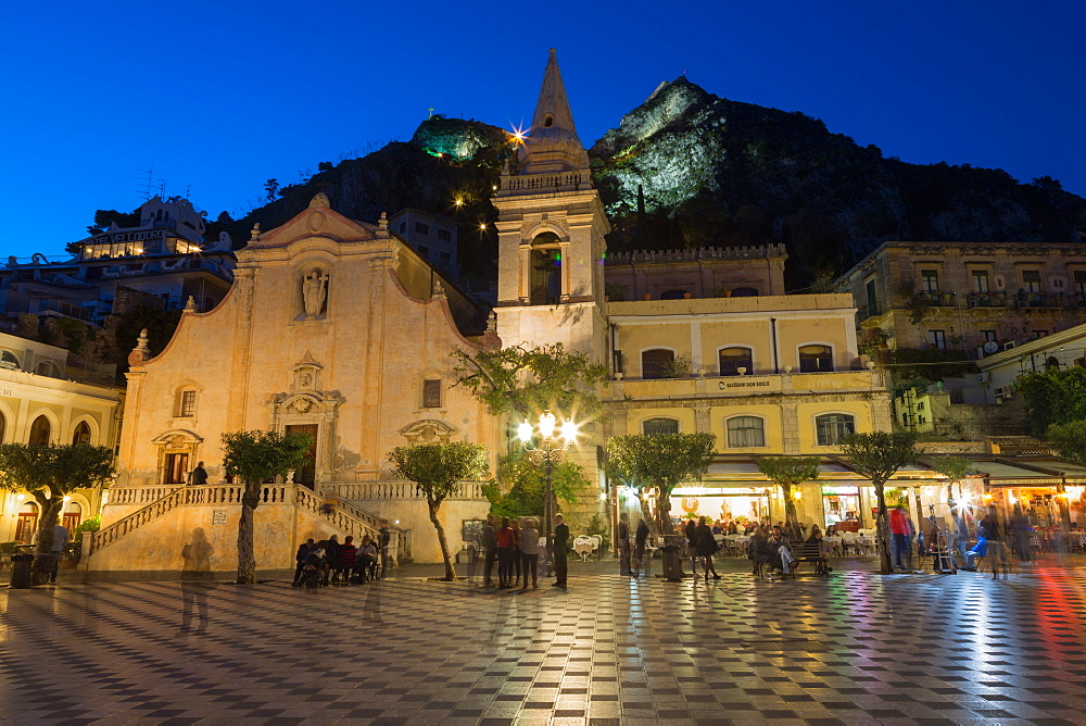 People enjoying passeggiata in Piazza IX Aprile in the hill town of Taormina at night, Sicily, Italy, Mediterranean, Europe