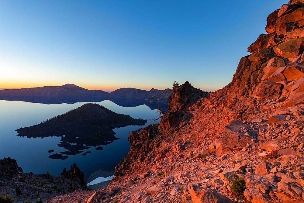 Wizard Island and the still waters of Crater Lake at dawn, the deepest lake in the U.S.A., part of the Cascade Range, Oregon, United States of America, North America