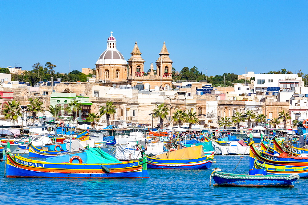 Traditional brightly painted fishing boats in the harbour at Marsaxlokk, Malta, Mediterranean, Europe