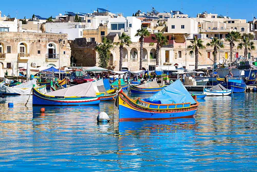 Traditional brightly painted fishing boats in the harbour at Marsaxlokk, Malta, Mediterranean, Europe