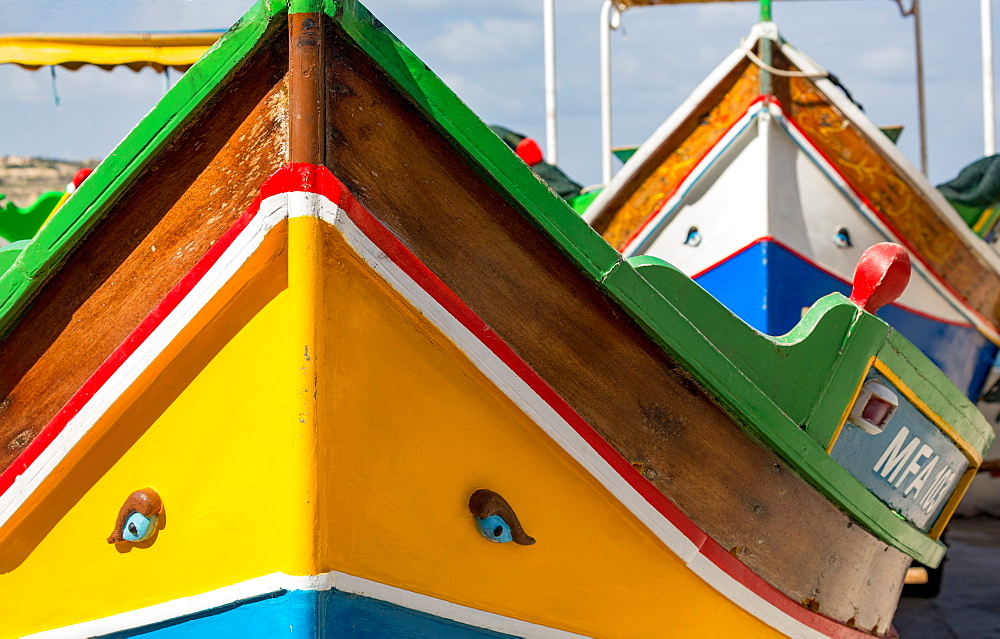 Detail of traditional brightly painted fishing boat in the harbour at Marsaxlokk, Malta, Mediterranean, Europe