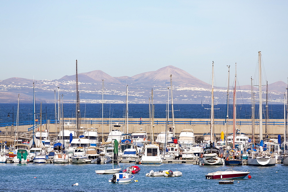 The harbour at Corralejo on the island of Fuerteventura with Lanzarote in the distance, Fuerteventura, Canary Islands, Spain, Atlantic, Europe