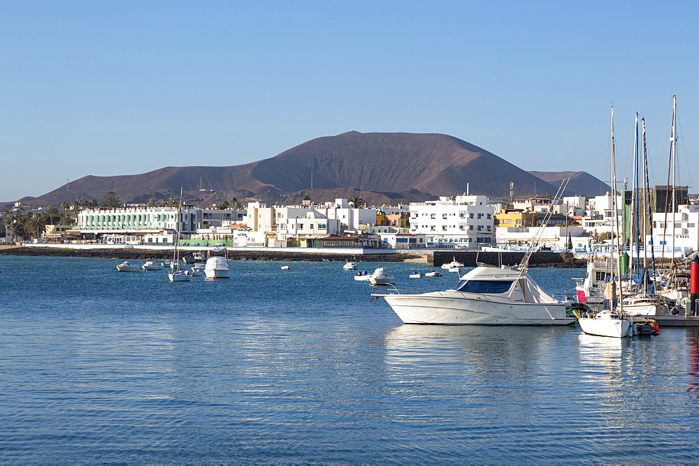 The harbour at Corralejo on the island of Fuerteventura with a volcano in the distance, Fuerteventura, Canary Islands, Spain, Atlantic, Europe