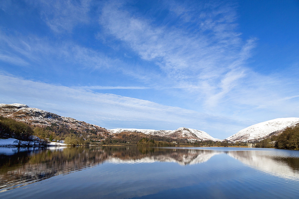 A perfect reflection of snow covered mountains and sky in the still waters of Grasmere, Lake District National Park, UNESCO World Heritage Site, Cumbria, England, United Kingdom, Europe