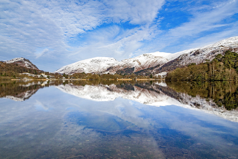 A perfect reflection of snow covered mountains and dramatic sky in the still waters of Grasmere, Lake District National Park, UNESCO World Heritage Site, Cumbria, England, United Kingdom, Europe