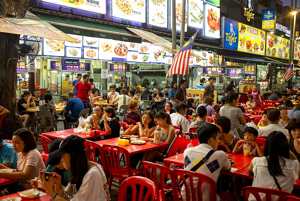 People enjoying a meal in Bukit Bintang food street at night in the capital city of Kuala Lumpur, Malaysia, Southeast Asia, Asia