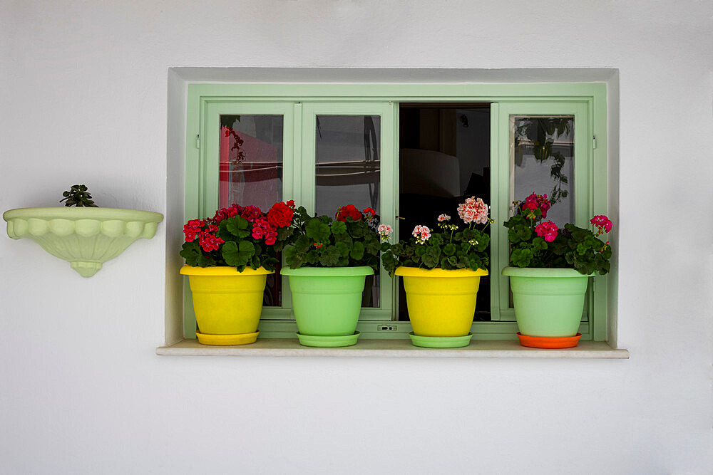 Colourful pots on windowsill in Naxos Town, Naxos, the Cyclades, Aegean Sea, Greek Islands, Greece, Europe