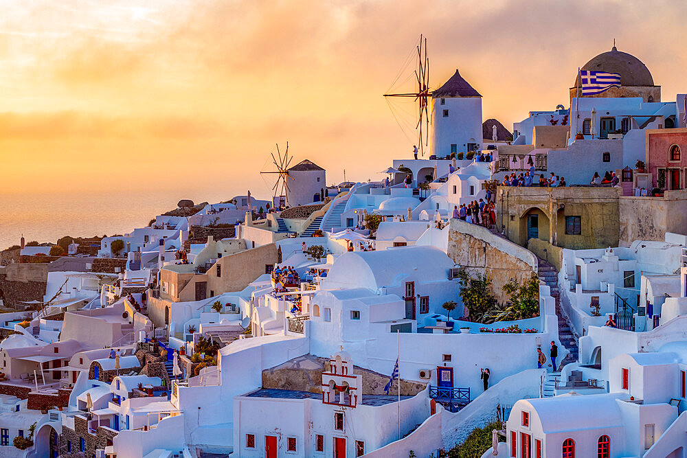 Sunset over windmills, Oia, on the clifftop overlooking the caldera, Santorini, The Cyclades, Aegean Sea, Greek Islands, Greece, Europe