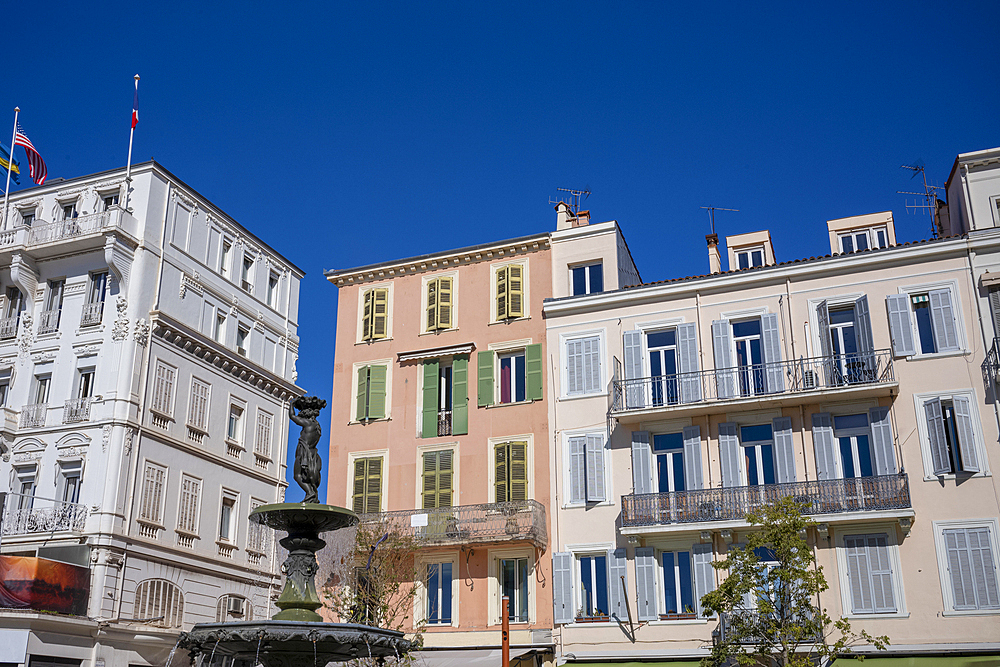 An ornate fountain in front of traditional apartments near Vieux Port, Cannes, Alpes-Maritimes, French Riviera, France