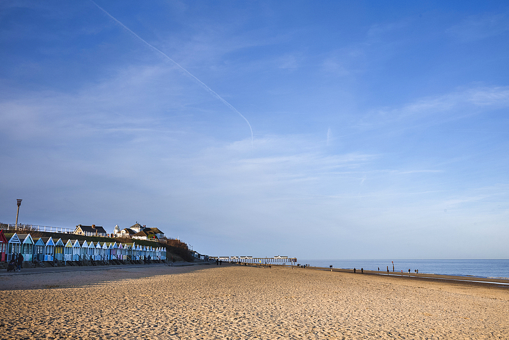 A row of colourful beach-huts on the beach at Southwold in the county of Suffolk, United Kingdom