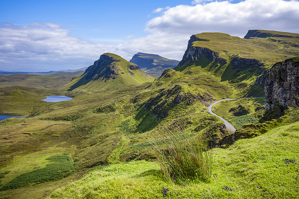 Narrow road running through the rugged hills of the Trotternish escarpment on the northernmost peninsula of the Isle of Skye, Inner Hebrides, Scotland.