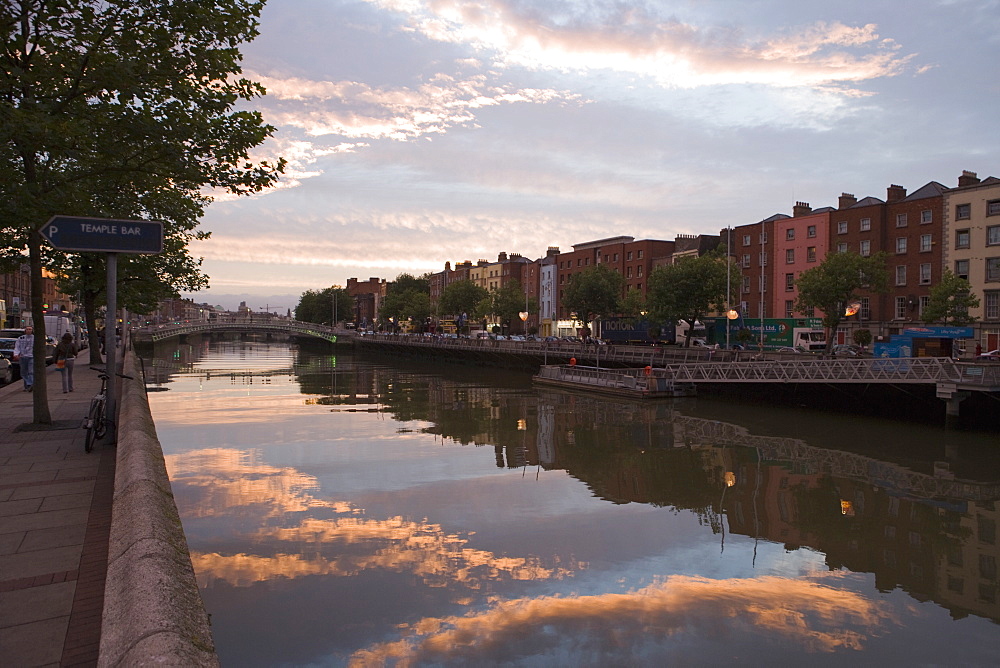 Still water and reflection at dusk, River Liffey, Ha'penny Bridge, Dublin, Republic of Ireland, Europe