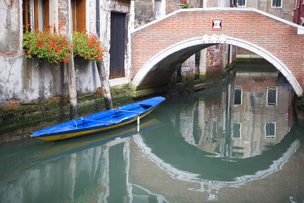 Bridge over canal with boat and buildings, Venice, Italy