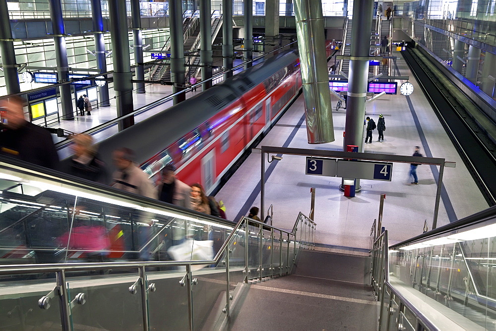 Moving train pulling into modern train station, Berlin, Germany, Europe