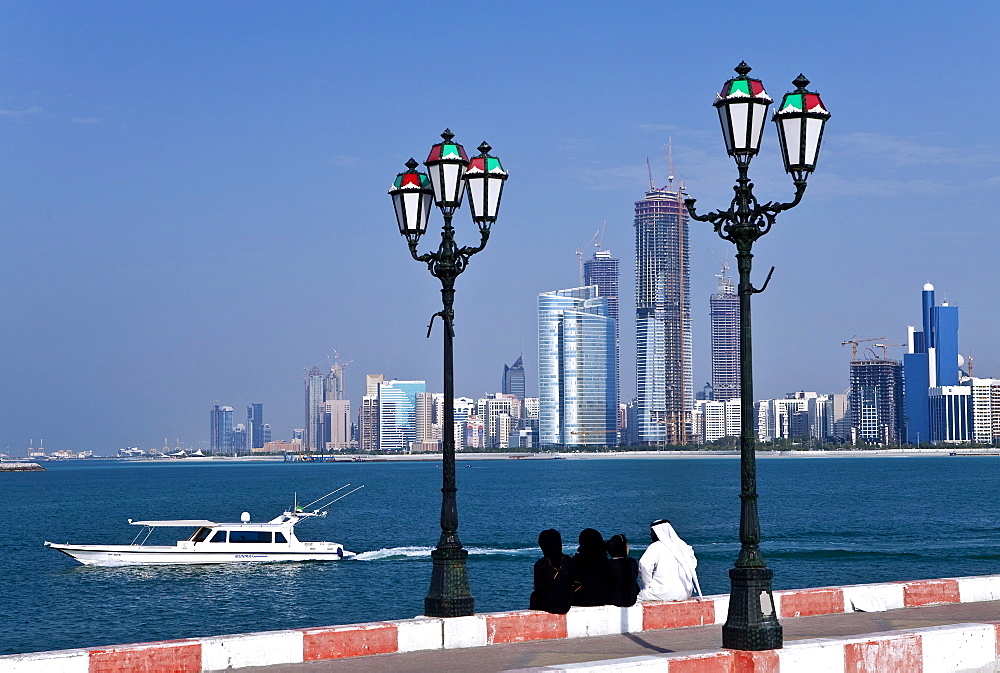 City skyline and the famous Corniche looking across the harbour from a pier, Abu Dhabi, United Arab Emirates, Middle East