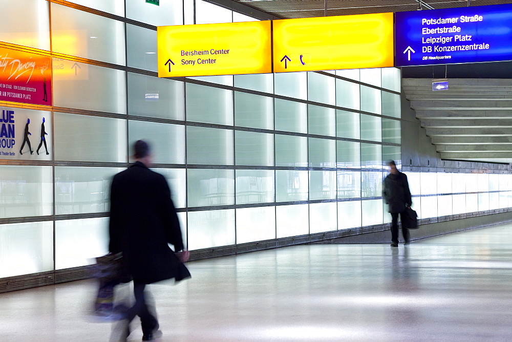 People walking with motion blur in modern train station passageway, Berlin, Germany, Europe